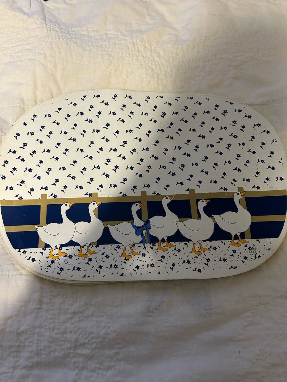 Vintage White Decorative placemats with Blue Goose Pattern.